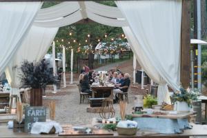 a group of people sitting at tables under a tent at AutoCamp Asheville in Asheville