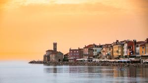 a group of buildings on the shore of the water at Apartma Mariella in Piran