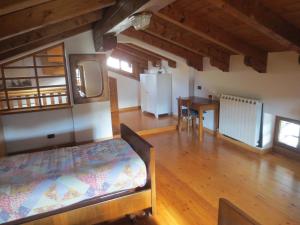 a bedroom with a bed and a table in a room at Casa del Calzolaio - Dobar Suostar in Stregna