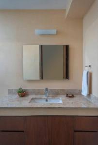 un baño con lavabo y espejo en Modern Studio w Balcony & Pool La Veleta, - Tulum - A207, en Tulum