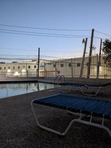 een bankje voor een zwembad bij Private room and bathroom in large spacious 2 BR 2 BH in San Juan