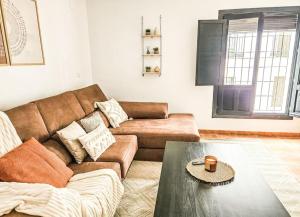 a living room with a couch and a coffee table at Pura Vida - Terraza, Piscina, Playa 15mn, Sierra in Vélez de Benaudalla