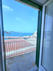 a view of the beach from a window at Maridea - Camere con vista al Porto in Ponza +29 photos