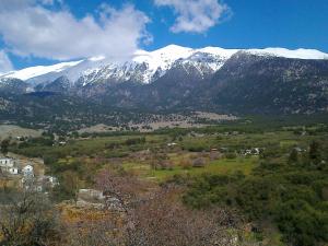 a mountain with snow capped mountains in the distance at house FYNTIKAKH - SKALA in Anopoli Sfakion