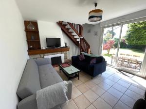 a living room with a couch and a fireplace at Maison Mboa in Fouesnant