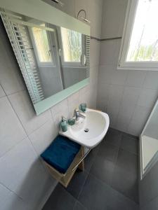 a bathroom with a sink and a mirror at Maison Mboa in Fouesnant +17 photos