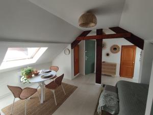 a living room with a table and chairs in a room at Mouette Rieuse in Malo-les-Bains