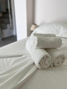 a stack of towels sitting on a bed at Alona Luxury Villas in Arkasa