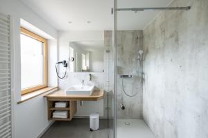 a bathroom with a sink and a shower at Haus Tannberg in Riezlern +35 photos