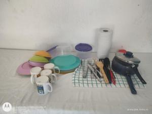 a table topped with plates and cups and utensils at Hidden Island Glamping Isla Mujeres in Isla Mujeres