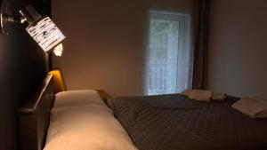 a bedroom with a bed and a lamp and a window at REST AND RESTAURANT in Roveredo in Roveredo