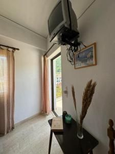 een woonkamer met een tv aan de muur bij Alecos Studios in Póros
