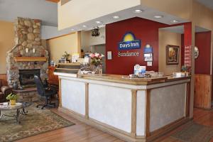 a restaurant with a reception counter with a fireplace at Days Inn by Wyndham Delta CO in Delta