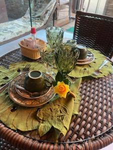 una mesa con platos y vasos en una mesa de mimbre en Pousada da Leide en Fernando de Noronha