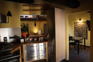 a kitchen with a counter and a table in a room at Mansarda Pescia in Pescia