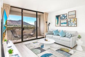 a living room with a couch and a large window at Newly Renovated 2 Bedroom Condo, 1 Block to Waikiki Beach, Free Parking in Honolulu