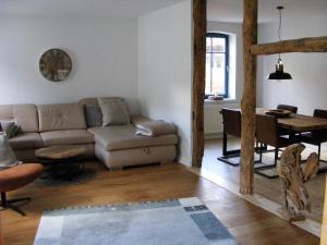 a living room with a couch and a table at Fuchsbau in Fischerhude