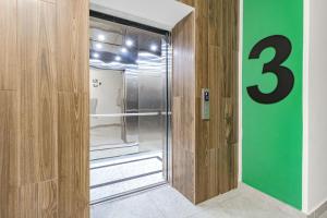 a room with a glass door with the number three at Светлая квартира in Zaozërnyy +15 photos