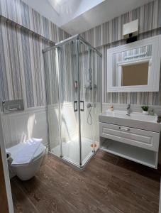 a bathroom with a shower and a toilet and a sink at Alaçatı Disa in Alaçatı +54 photos