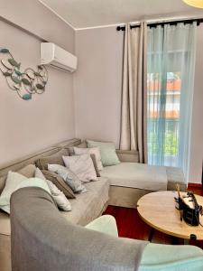 a living room with a couch and a table at Brand new brilliant apartment at Athenian Riviera in Athens