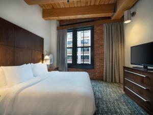 a hotel room with a bed and a television at Residence Inn by Marriott Boston Downtown Seaport in Boston