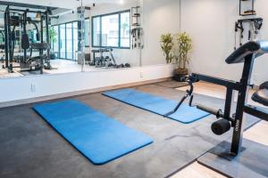 a fitness room with blue mats and a gym at Beach Paradise Luxury Views Here in Rosarito