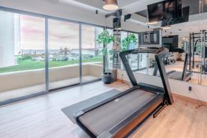 a gym with a treadmill and large windows at Beach Paradise Luxury Views Here in Rosarito