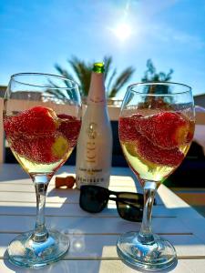 two glasses of wine sitting on a table at Apartamento DESA Laguna Beach Vera Playa in Vera