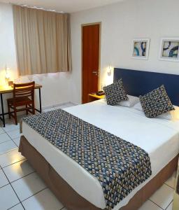 a bedroom with a large bed in a hotel room at Villa Park Hotel Fortaleza - antes Hotel Villamaris in Fortaleza