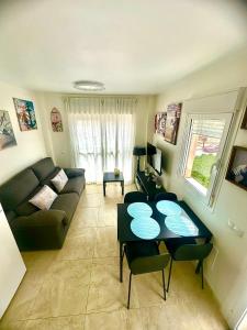 a living room with a couch and a table at Apartamento DESA Laguna Beach Vera Playa in Vera +38 photos