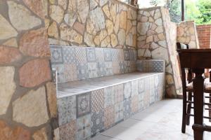 a stone wall with a bench in a room at Villa Mare E Monti in Castellammare del Golfo