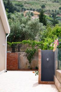 a black door on the side of a house at Villa Mare E Monti in Castellammare del Golfo