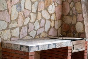 a stone wall with a bench in a room at Villa Mare E Monti in Castellammare del Golfo