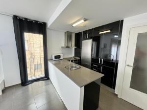 Kuchyň nebo kuchyňský kout v ubytování APARTAMENTO ROMELIA 1ºa