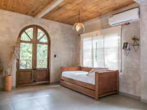 a bedroom with a bed and a window and a door at Salvia Madre in Santa Marta