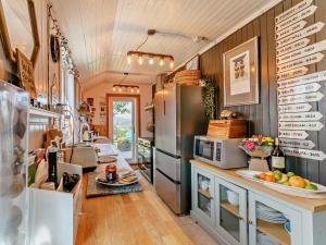 eine Küche mit einem Kühlschrank und einer Theke mit einer Obstschale in der Unterkunft 3 Bed in Pitlochry 59677 in Pitlochry