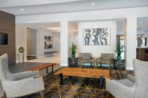 a lobby with chairs and a table in a room at Holiday Inn Miami-Doral Area, an IHG Hotel in Miami