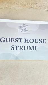 a sign for a guest house stimunit at Guest house Luli Strumi in Berat