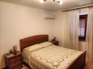 a bedroom with a bed and a window at A due passi dal Duomo in Cefalù