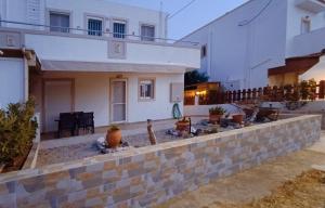 a house with a retaining wall in front of it at G.S. Apartment in Mastichari