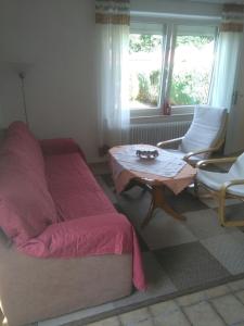 a bedroom with a bed and a table and chairs at Ferienhaus "Buchfink" in Berumbur