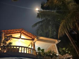 亞蘭博的住宿－Double V Arambol，前面有棕榈树的建筑