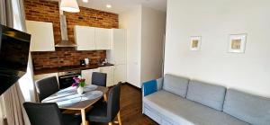 a small kitchen and dining room with a table and chairs at Villa Loebel - One bedroom apartment with balcony in Juodkrantė