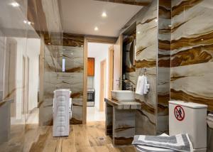 a bathroom with a toilet and a sink at Loridis Central Apartments in Prinos +127 photos