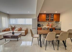 a living room with a table and chairs at Loridis Central Apartments in Prinos
