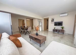 a living room with a couch and a table at Loridis Central Apartments in Prinos