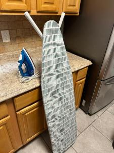 a surfboard sitting on top of a kitchen counter at Fidelia Amethyst Room, King Bed and Twin Bed with Private Bathroom Minutes From Newark Liberty International Airport and Newark Penn Station in Irvington +5 photos