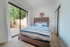 a bedroom with a bed and a large window at Beautiful 4 bedroom house in gold coast in Palm-Eagle Beach +55 photos