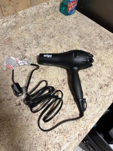 a black hair dryer sitting on a counter at Fidelia Amethyst Room, King Bed and Twin Bed with Private Bathroom Minutes From Newark Liberty International Airport and Newark Penn Station in Irvington