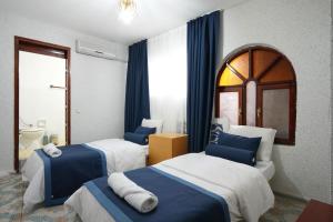 a hotel room with two beds and a window at OzenTurku Hotel in Pamukkale +138 photos